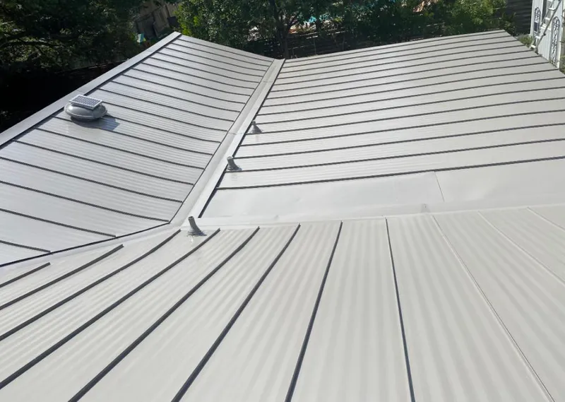 Solar attic fan installed on a metal roof for Roof Ventilation in West Slope